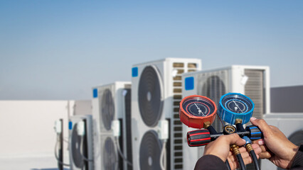 Air conditioner technician checks the operation of industrial air conditioners.