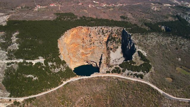Red lake(Crveno jezero) in Imotski, Croatia is a limestone crater, with cliffs 200 m high and a lake 300 m deep.
