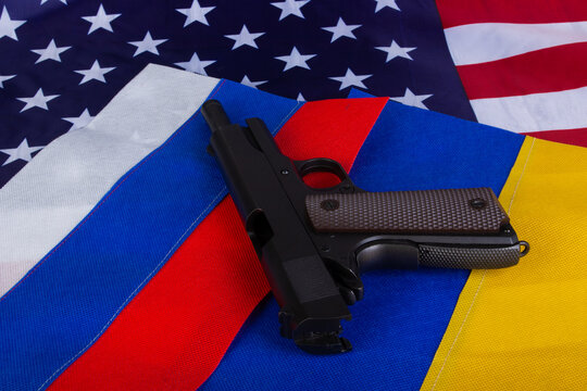 Flags of the USA, Russia, Ukraine with gun on the background . Peace concept