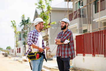 Two construction engineer man team in  safety uniform working and  planing in construction site. Maintenance service Repair and handyman concept