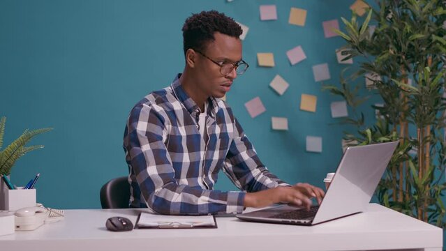Angry employee having furious reaction about business work, feeling furious while he uses laptop computer on desk. Office worker feeling annoyed and tense about job problem, freelance failure.