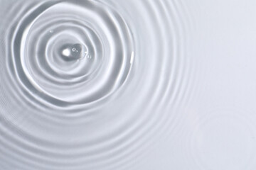 Closeup view of water with circles on light background