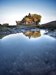 tanah lot temple in the morning with water reflection