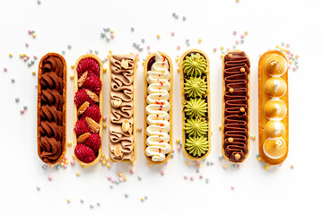 Set of delicious dessert eclairs with colorful topping