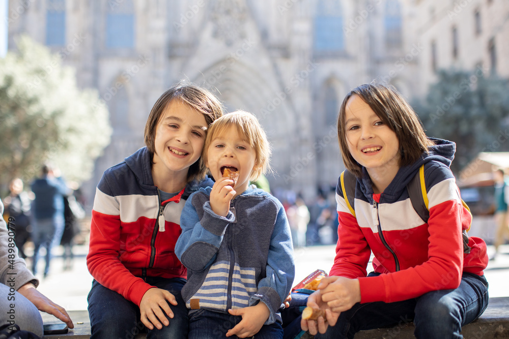 Wall mural cute little children tourists admiring barcelona city, family travel with kids