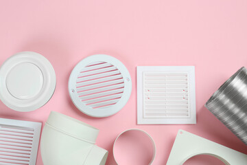 Parts of home ventilation system on pink background, flat lay. Space for text