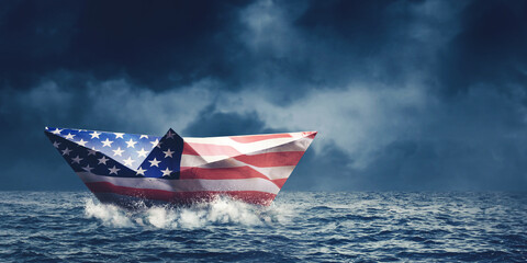 Paper boat with America flag floating on the sea
