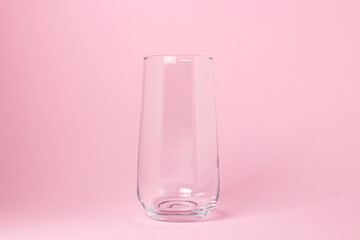 Empty glass on a pink background. Glass transparent cocktail glass. Glassware