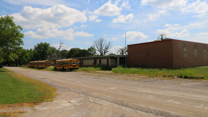 abandoned rural town school education building pandemic closure buses dirt road editorial closed...