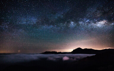 Colorful lighting reflect on the mountain with beautiful galaxy , Hehuan Mountain, Taiwan - the...