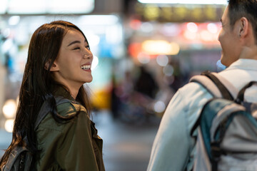 Asian active young couple travel in city for honeymoon trip at night.