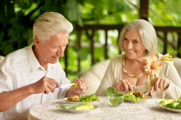 Portrait of happy senior couple having diner