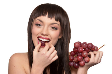 Portrait of young woman posing with grapes