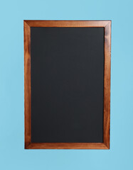 Fototapeta premium Clean black chalkboard on light blue background