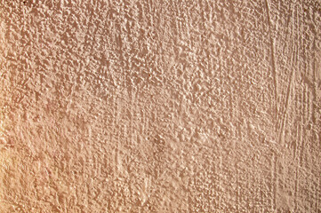 The plastered surface of the wall is beige as a background.