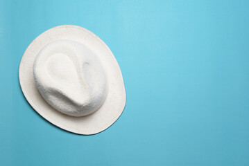A classic fedora hat in a white color. Isolated on blue