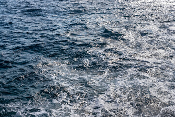 Fototapeta na wymiar Blue water surface with small waves at sea