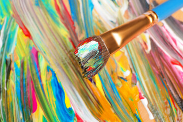 Abstract colorful acrylic paint and brush, closeup view