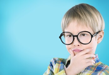 Healthy eyes and vision. Portrait nerd kid child with question face wearing eyes glasses.