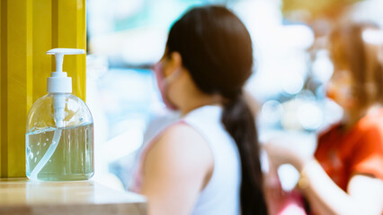 Blue alcohol gel bottle for hand cleaning to prevent the spreading of the Corona virus (Covid-19),Place on the table service for customers in front of the cafe.New normal lifestyle.Healthcare concept.