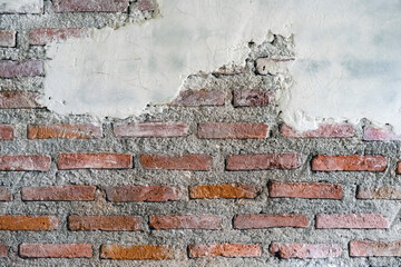 Cracked brick and concrete wall. Old bricks wall and cement. Texture of brick wall pattern...