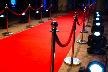 Red carpet with barriers and red ropes.