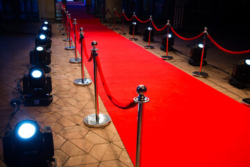 Red carpet with barriers and red ropes.
