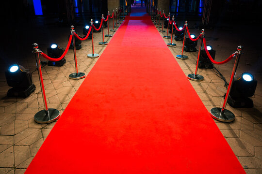 Red carpet with barriers and red ropes.