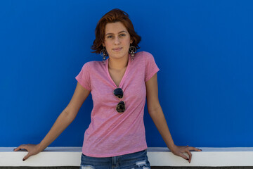 Medium shot of young woman (22) Latin American redhead looking in front of camera with relaxed...