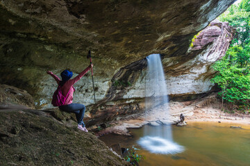 Young woman hiking in Sang Chan Waterfall, Beautiful waterfall in Pha Tam national Park, Ubon Ratchathani  province, ThaiLand.