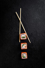 Fototapeta na wymiar traditional japanese sushi dish, rolls. Sushi on a dark background