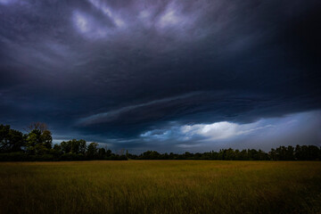 Obraz na płótnie Canvas Rain and storm clouds darken the sky over a country lane near Augsburg