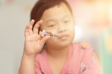kid hold vaccine in hand fingertip