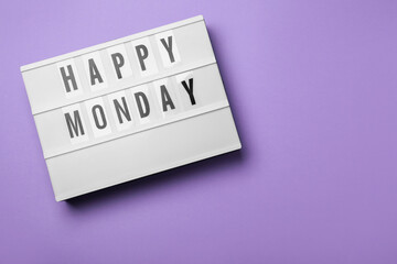 Light box with message Happy Monday on lilac background, top view. Space for text