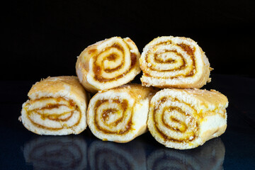 Sweet rolls with stuffing on the table with reflection