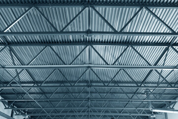 Roof or metal ceiling of industrial premises. Inside view. From bottom up. New building. Metal...