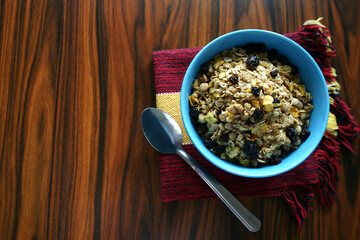 Bowl with granola seen from above with spoon.