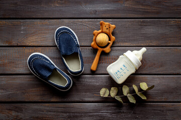 Baby newborn accessories with blue booties bootle of milk and toy