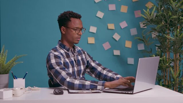 Overworked employee showing timeout gesture with hands, asking for break and pause from work at office desk. Tired person raising arms in defense, refusing to do job on laptop. Stop