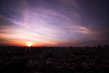 Rising sun with city silhouette skyline. Cinematic sky in the Brazilian city.