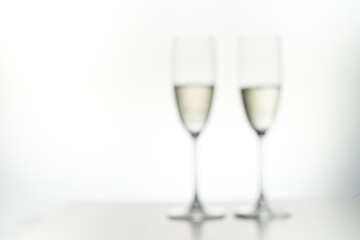 Blur of Two glasses of champagne. Isolated in white. Drunkenness concept.