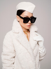Beautiful young lady in a white faux fur coat - 489913716