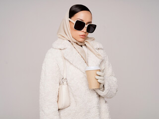 Beautiful young lady in a white faux fur coat - 489913719