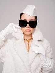 Beautiful young lady in a white faux fur coat - 489913759