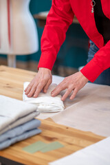 Womans hands touching bundle on table