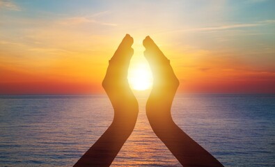 Summer sun concept with silhouette of young woman's hands relaxing, happy meditating