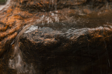 close up of water falling on the rock. spray water. blurred water effect