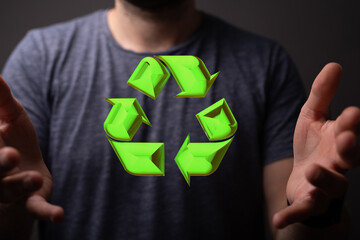 hand holding green recycle symbol