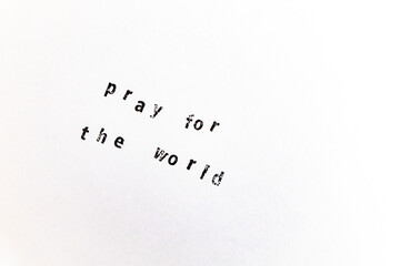 Pray for the world machine stamps on a white paper background