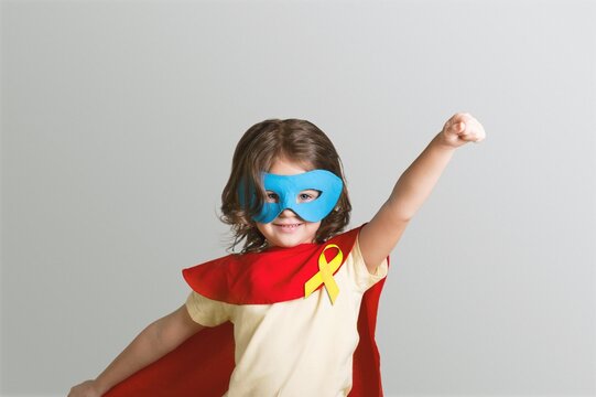 World Childhood cancer Day.  Girl in superhero costume posing